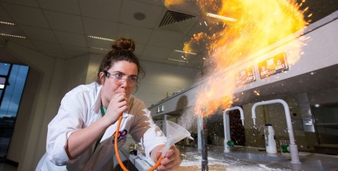 Laurie Ryan blowing flames at the annual Chemistry Demonstration Workshop 2017, engaging science teachers