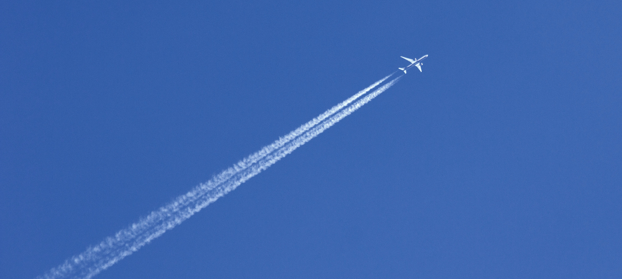 An aircraft in the sky seen from the ground.